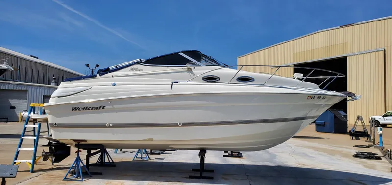 Slide: The Image of 2003 Wellcraft 2400 Martinique boat on stands in a marina setting. - 2