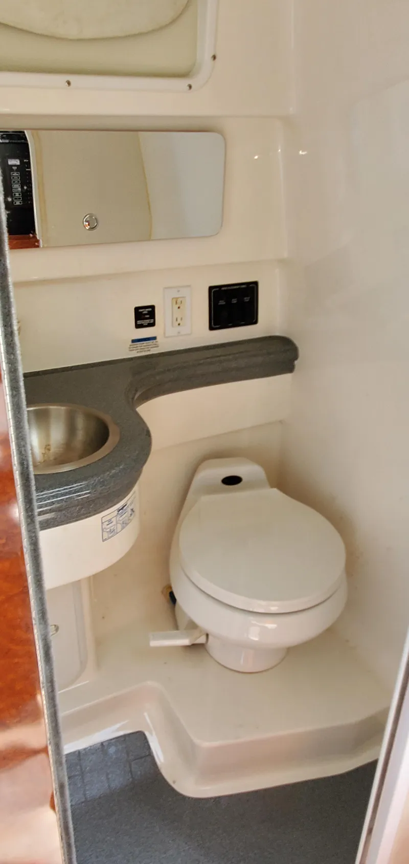 Slide: The Image of 2003 Wellcraft 2400 Martinique boat bathroom with sink, toilet, and mirror. - 23