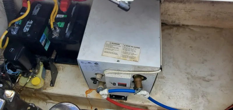 Slide: The Image of Engine compartment of a 2003 Wellcraft 2400 Martinique boat with battery and wiring. - 24