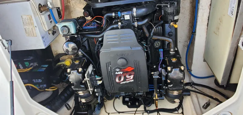 Slide: The Image of Engine compartment of a 2003 Wellcraft 2400 Martinique boat, featuring a MerCruiser 5.0 MPI engine. - 27