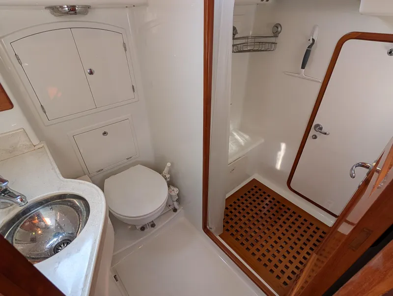 Slide: The Image of Interior of 2015 Outbound 46 yacht, featuring wooden doors and a grid-patterned floor. - 24