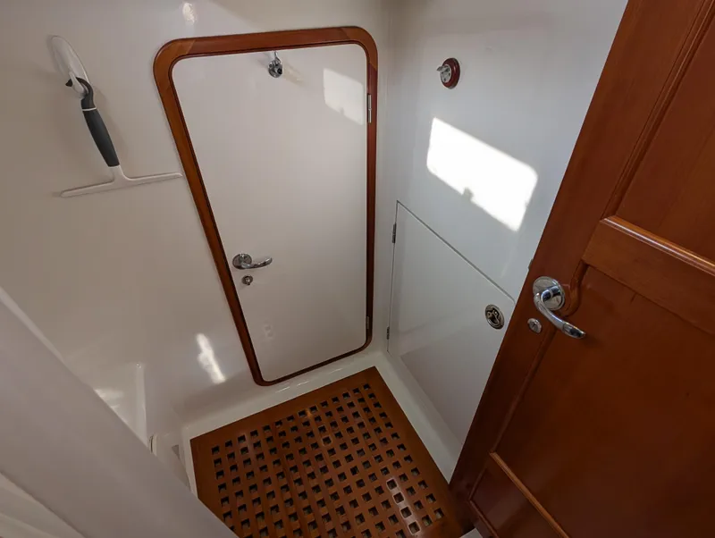 Slide: The Image of Interior of 2015 Outbound 46 yacht, featuring a compact, well-lit cabin space. - 25