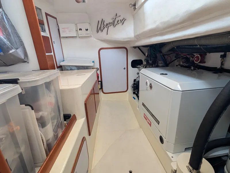 Slide: The Image of Engine room of a 2015 Outbound 46 yacht featuring a Northern Lights generator. - 27