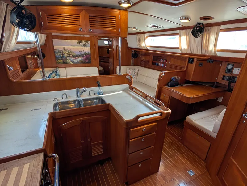 Slide: The Image of Luxurious interior of 2015 Outbound 46 yacht with elegant wood finish and cozy seating. - 3