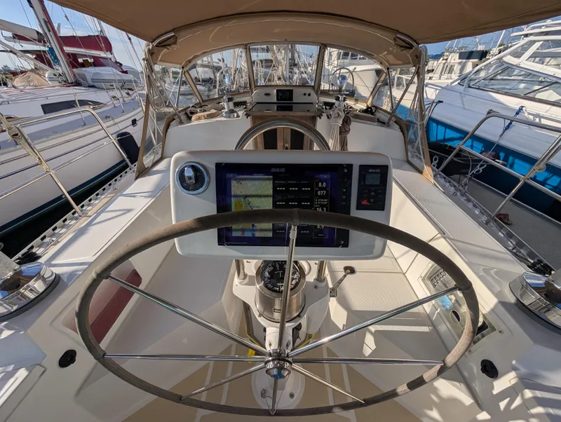 Slide: The Image of Cockpit view of 2015 Outbound 46 sailboat with navigation equipment and steering wheel. - 32