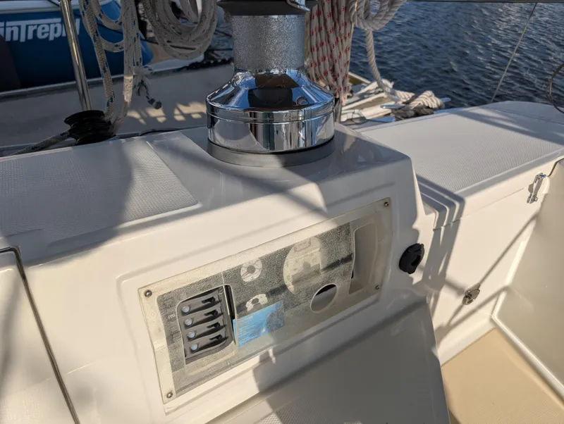 Slide: The Image of Cockpit of 2015 Outbound 46 sailboat with tan canvas cover and winch. - 40