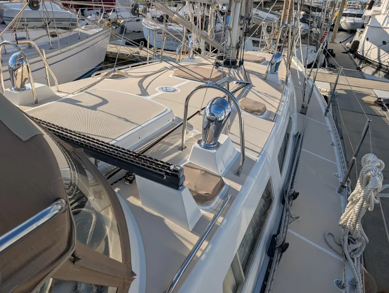 Slide: The Image of Sailboat deck of 2015 Outbound 46, docked at marina with visible rigging and hatches. - 43