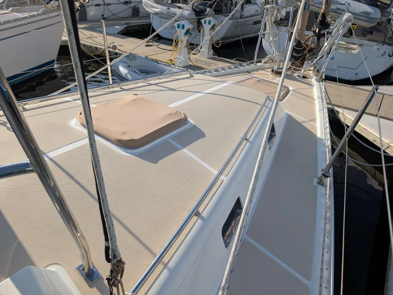 Slide: The Image of 2015 Outbound 46 sailboat deck with beige canopy and rigging, docked at marina. - 44