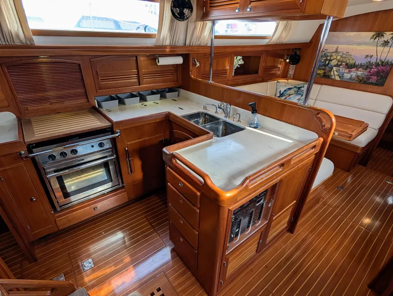 Slide: The Image of Luxurious 2015 Outbound 46 yacht interior with elegant wood cabinetry and modern kitchen amenities. - 5