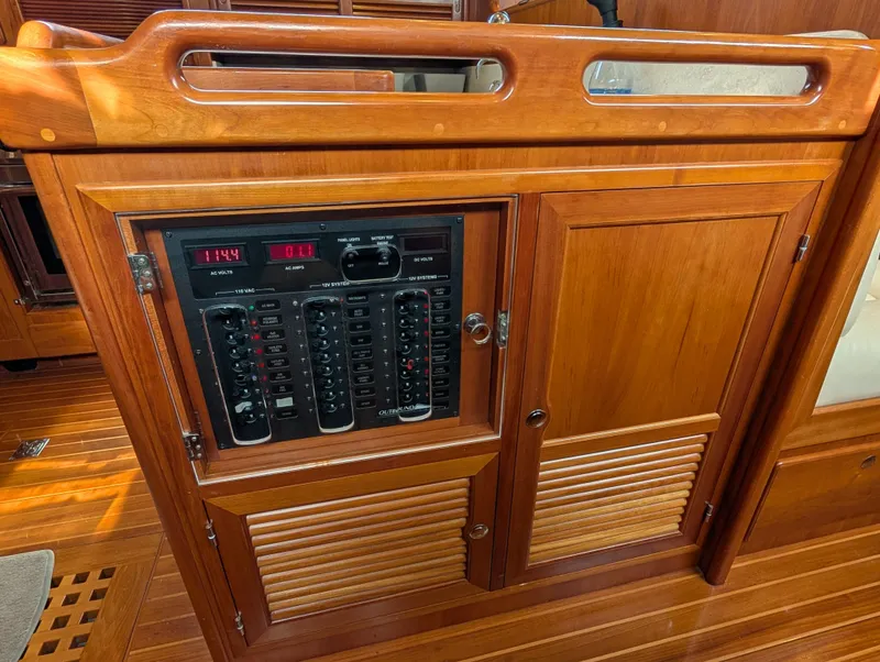Slide: The Image of Electrical control panel on a 2015 Outbound 46 yacht, featuring AC and DC systems. - 9
