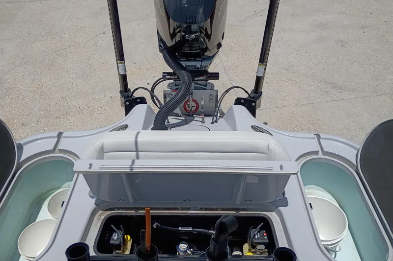 Slide: The Image of 2025 Yellowfin 24 CE boat interior with open storage compartments and engine view. - 11