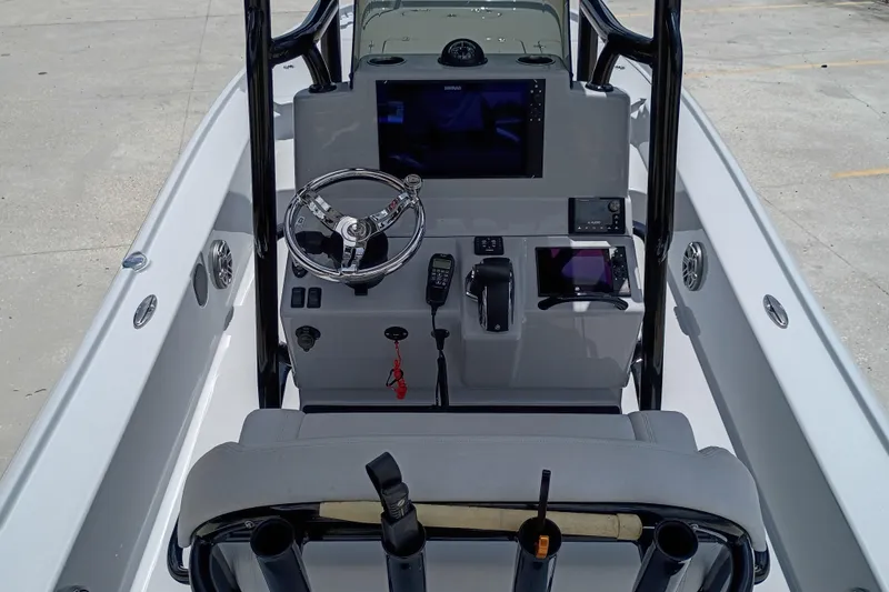 Slide: The Image of 2025 Yellowfin 24 CE boat console with steering wheel and navigation equipment. - 12