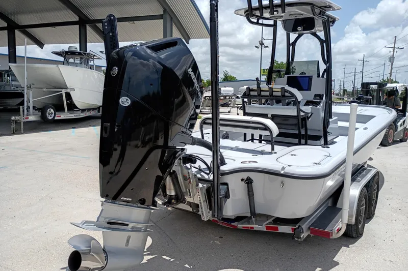 Slide: The Image of 2025 Yellowfin 24 CE boat with powerful outboard motor, parked on a trailer. - 2