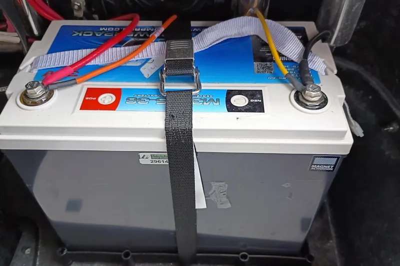 Slide: The Image of Battery secured in a 2025 Yellowfin 24 CE boat, featuring colorful wiring connections. - 23