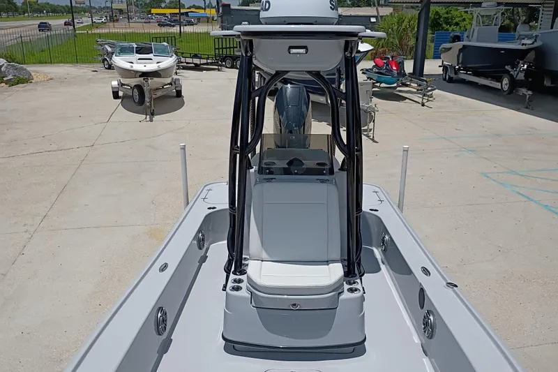 Slide: The Image of 2025 Yellowfin 24 CE boat on display at a dealership, showcasing sleek design and modern features. - 24
