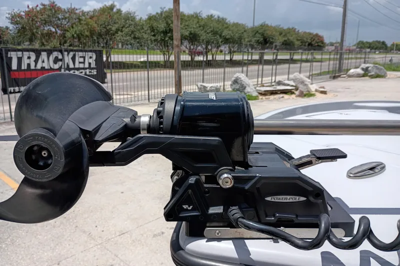 Slide: The Image of 2025 Yellowfin 24 CE boat with Power-Pole anchor system, parked near Tracker Boats sign. - 7