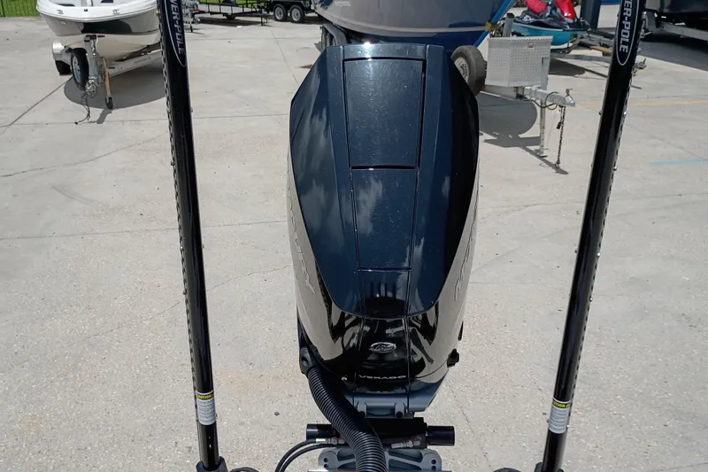 Slide: The Image of 2025 Yellowfin 24 CE boat engine with Power-Pole anchors in a marina setting. - 9