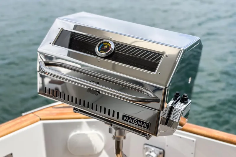 Slide: The Image of Stainless steel Magma grill on 2014 Beneteau Swift Trawler 34, overlooking water. - 11