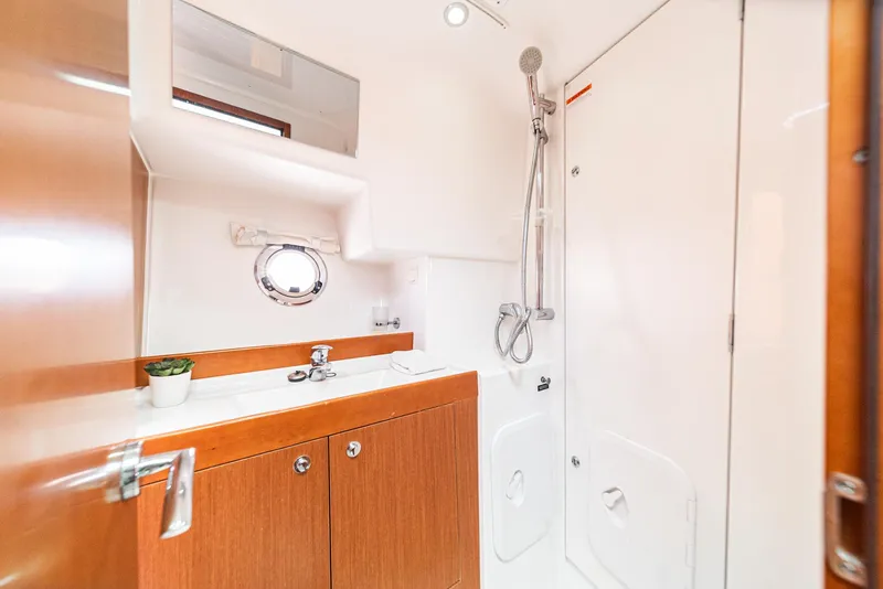 Slide: The Image of Bathroom of 2014 Beneteau Swift Trawler 34 with shower and wooden cabinetry. - 19