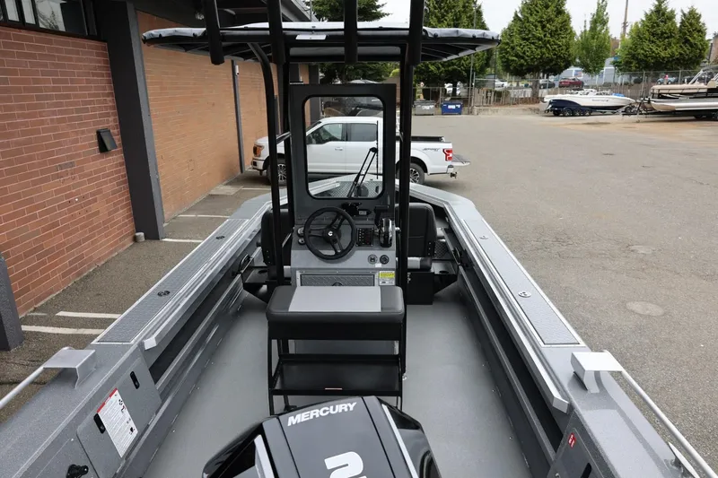 Slide: The Image of 2026 Thunder Jet 209 Rush Center Console boat with Mercury engine in a parking lot. - 11