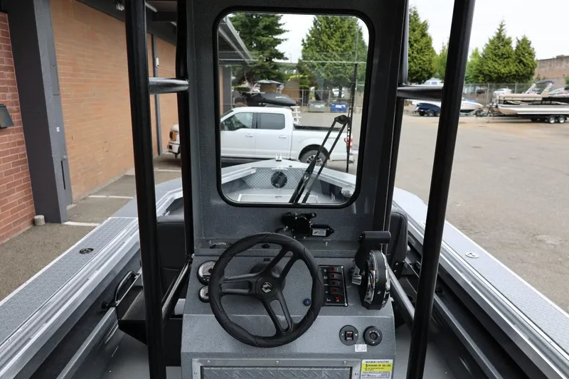 Slide: The Image of 2026 Thunder Jet 209 Rush Center Console boat interior with steering wheel and controls. - 15