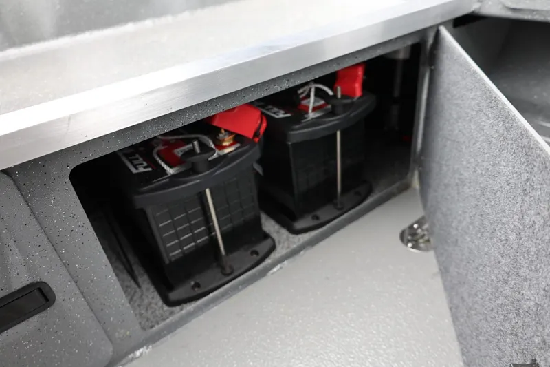 Slide: The Image of 2026 Thunder Jet 209 Rush Center Console battery compartment with dual batteries. - 32