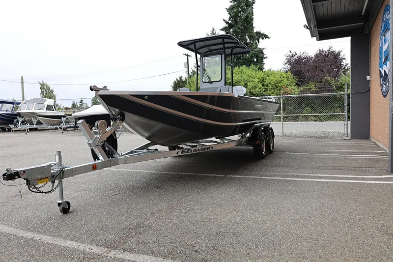 Slide: The Image of 2026 Thunder Jet 209 Rush Center Console boat on trailer in parking lot. - 5