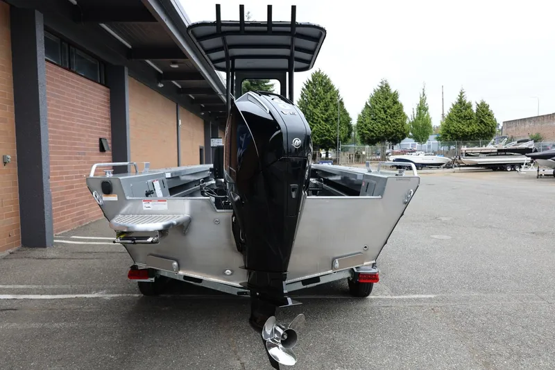 Slide: The Image of 2026 Thunder Jet 209 Rush Center Console boat with powerful outboard motor, parked outdoors. - 8