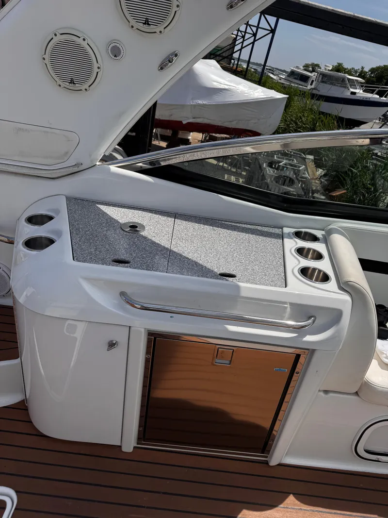 Slide: The Image of 2009 Formula 350ss boat interior with white seating and control panel at marina. - 10