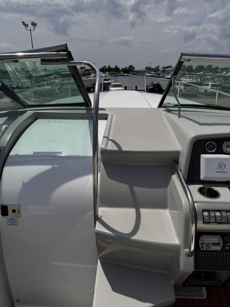 Slide: The Image of 2009 Formula 350ss boat cockpit with dashboard and steps, docked at marina. - 12