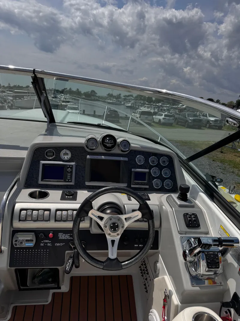 Slide: The Image of 2009 Formula 350SS boat interior with white seating and wood flooring. - 16