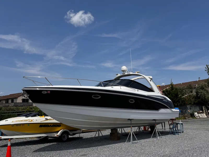 Slide: The Image of 2009 Formula 350ss boat with sleek design under cloudy sky. - 2