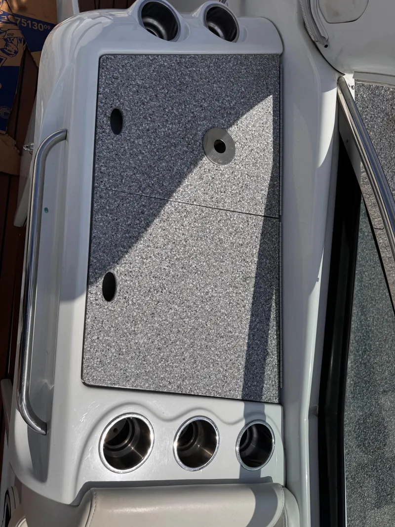 Slide: The Image of 2009 Formula 350 Sun Sport cabin with beige seating and table, featuring decorative pillows. - 21