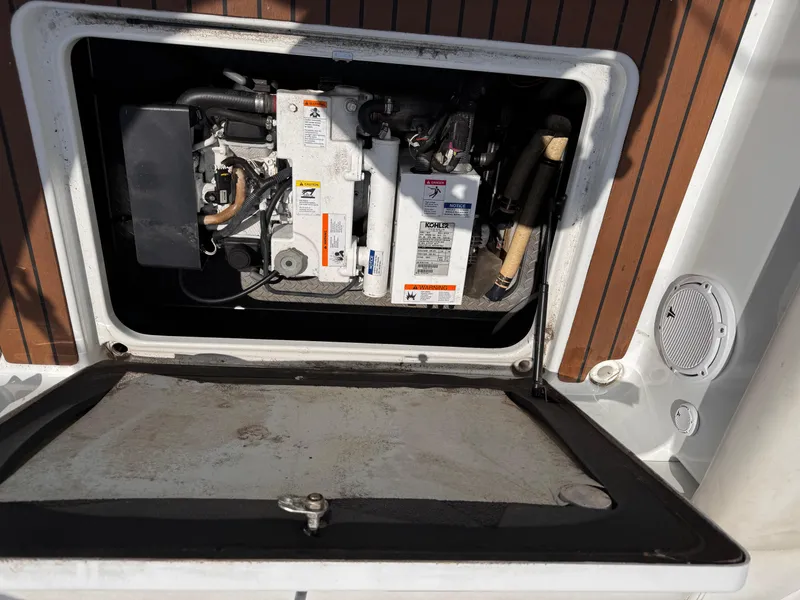 Slide: The Image of 2009 Formula 350 Sun Sport interior with kitchenette, featuring sink, microwave, and elegant wood cabinetry. - 24