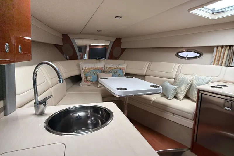 Slide: The Image of 2009 Formula 350 Sun Sport cabin with plush seating, kitchenette, and modern amenities. - 25