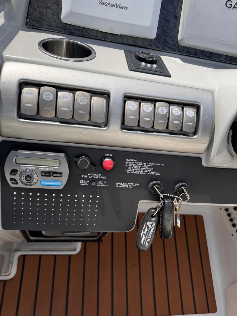 Slide: The Image of 2009 Formula 350ss boat cockpit with dashboard and steps, marina in background. - 3