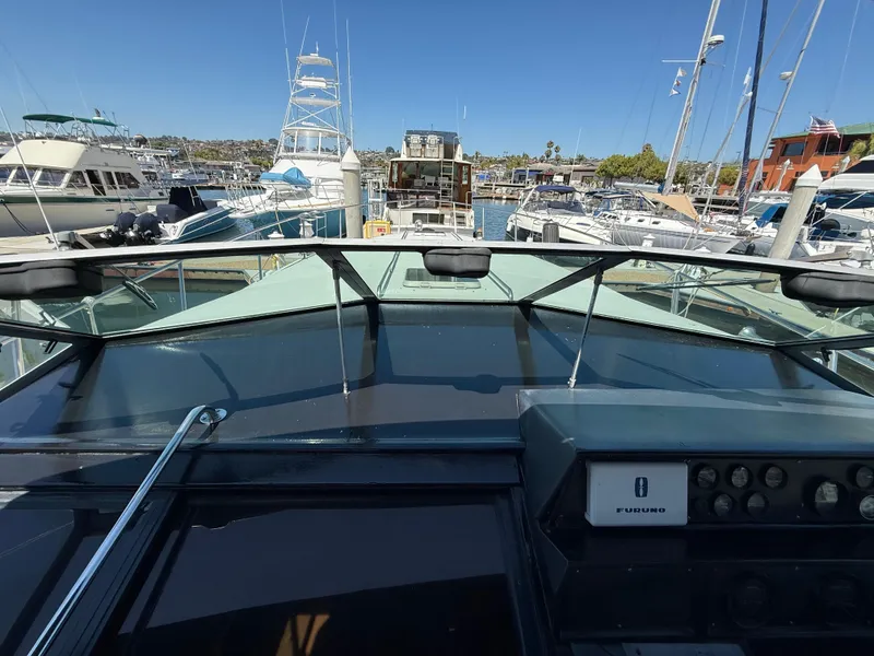 Slide: The Image of 1986 Sea Ray 460 Express Cruiser at marina, view from helm, clear sky. - 17