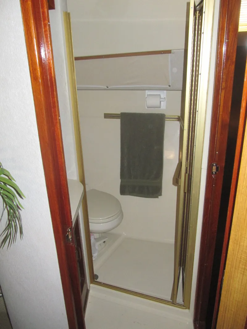 Slide: The Image of Bathroom interior of 1986 Sea Ray 460 Express Cruiser with towel and toilet. - 20