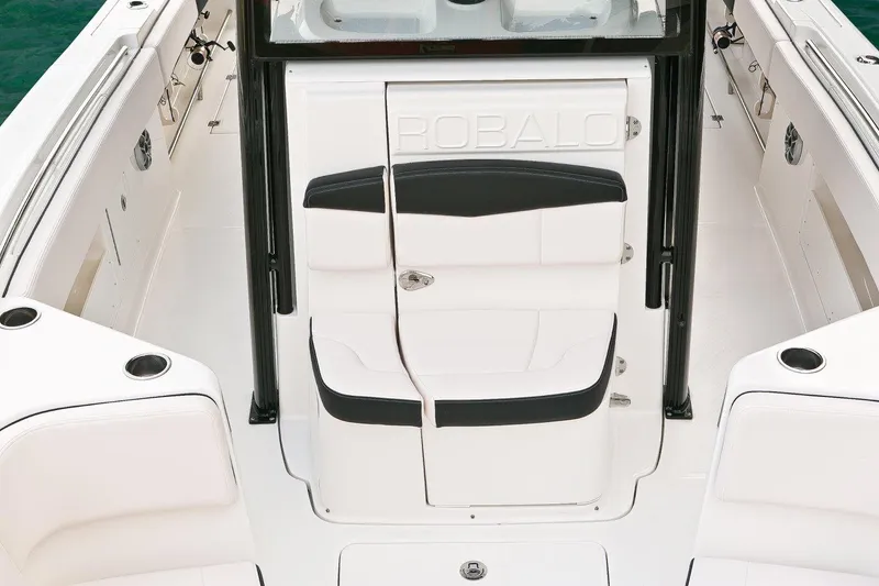 Slide: The Image of Manufacturer Provided Image: 2017 Robalo R302 Center Console boat interior with white seating and storage compartments. - 6