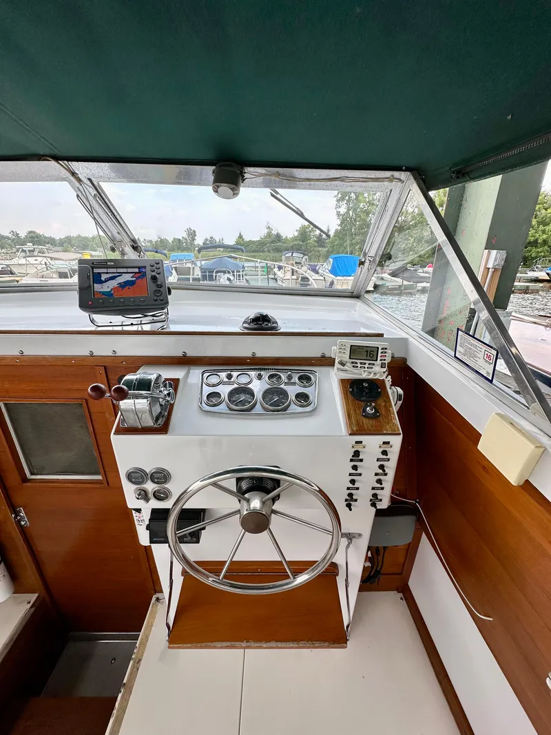 Slide: The Image of 1966 Bertram 31 Bahia Mar helm with vintage controls and modern navigation equipment. - 6