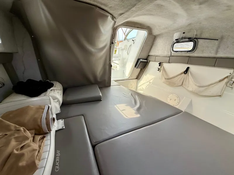 Slide: The Image of Interior cabin of 2002 Glacier Bay 2670 Island Runner with gray cushions and storage pockets. - 10