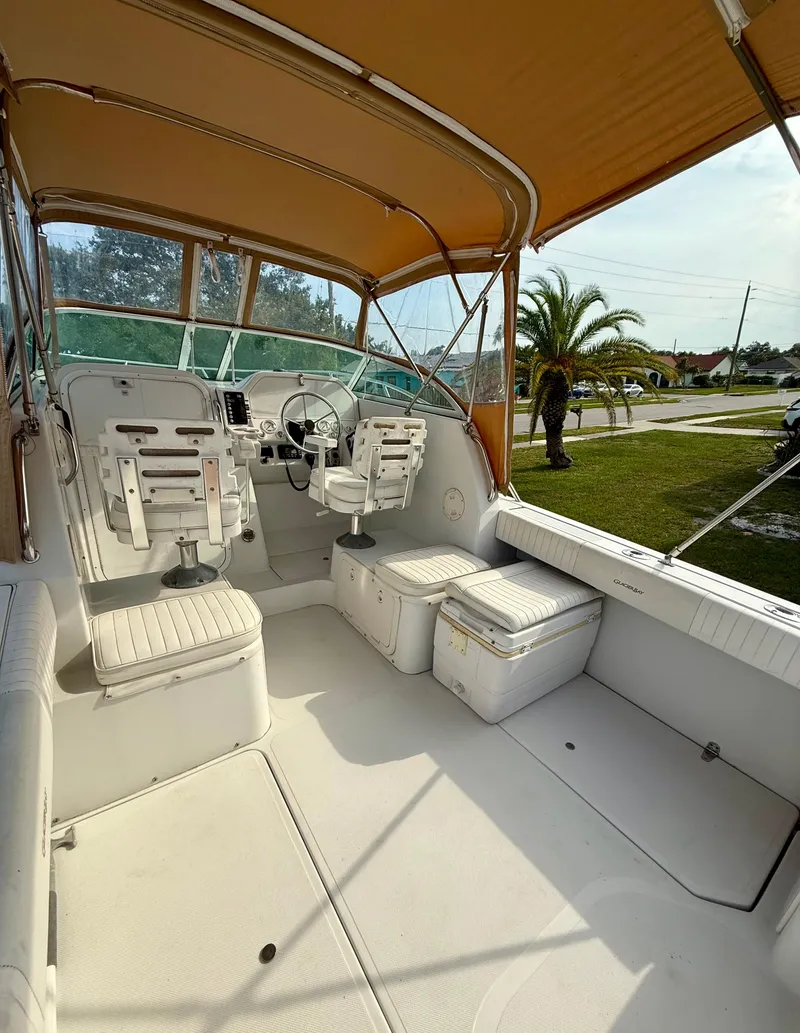 Slide: The Image of 2002 Glacier Bay 2670 Island Runner boat interior with seating and steering wheel. - 6