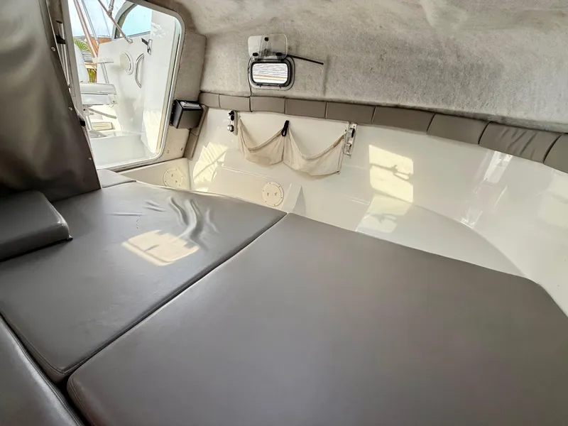 Slide: The Image of Interior cabin of 2002 Glacier Bay 2670 Island Runner boat, featuring cushioned seating. - 9