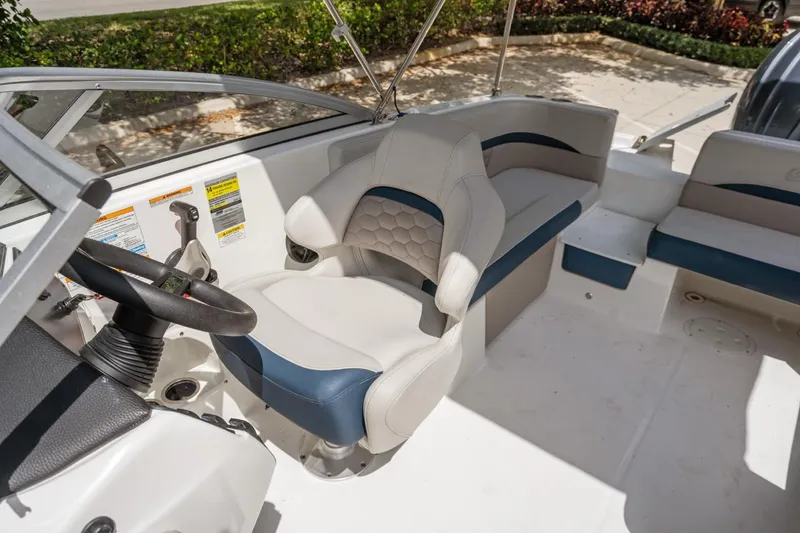 Slide: The Image of 2025 Hurricane SunDeck 217 OB boat interior with steering wheel and seating. - 8