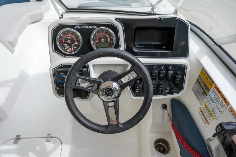 Slide: The Image of Steering console of 2025 Hurricane SunDeck 2050 OB boat with gauges and controls. - 12