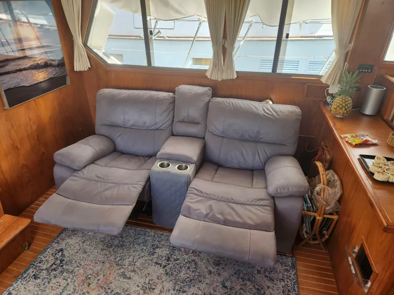 Slide: The Image of Cozy seating area on a 1987 Kha Shing 38 yacht with recliners and nautical decor. - 5