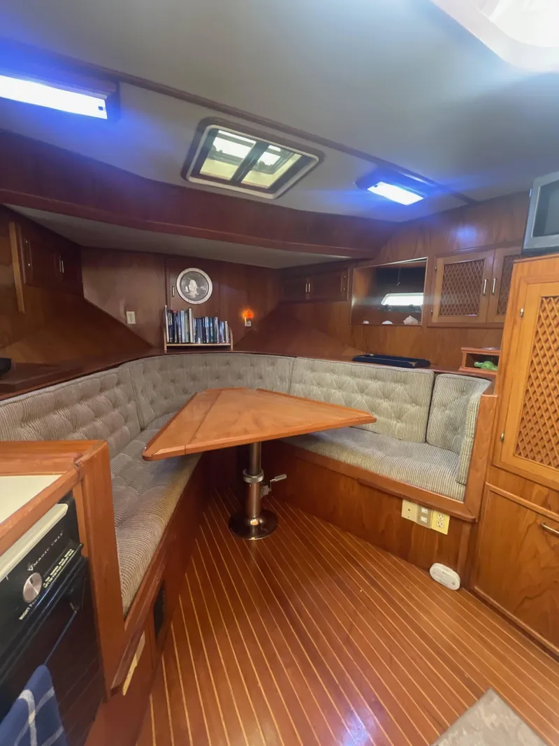 Slide: The Image of Cozy interior of 1987 Kha Shing 38 yacht with wood paneling and cushioned seating. - 6