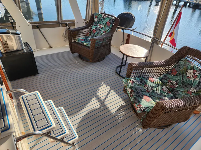 Slide: The Image of Cozy deck of 1987 Kha Shing 38 yacht with wicker chairs and floral cushions. - 8