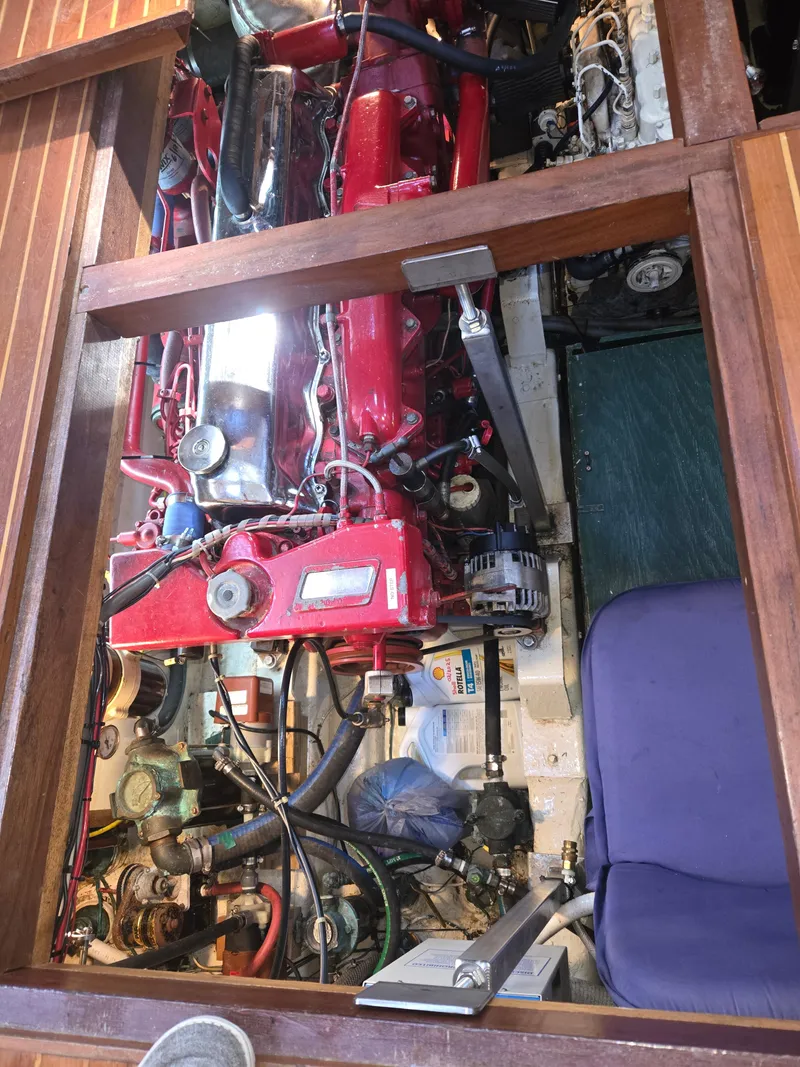Slide: The Image of Engine compartment of a 1987 Kha Shing 38 boat, featuring a red engine. - 9