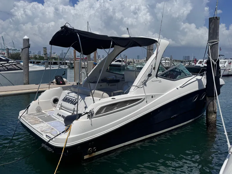 Slide: The Image of 2012 Sea Ray 330 Sundancer docked at marina under cloudy sky. - 0